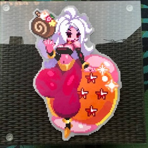 May include: A pink and white pixel art figure of a female character with long white hair, wearing a red and gold outfit, holding a brown swirl-shaped object. The figure is standing on a pink and orange pixel art object with a gold outline and stars.