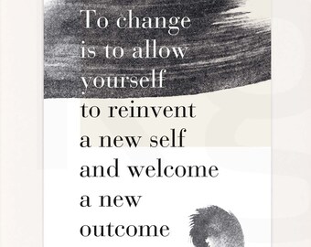 May include: A framed black and white inspirational quote print with the text "To change is to allow yourself to reinvent a new self and welcome a new outcome". The print is in a black frame and is sitting on a table with a green plant and three books.