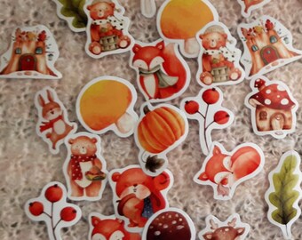 May include: A collection of autumn-themed stickers featuring foxes, mushrooms, houses, pumpkins, and leaves. The stickers are illustrated in a watercolor style with warm colors like orange, red, and brown.