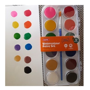 May include: A set of 12 watercolor paints in a plastic case with a brush. The paints are in round pans and are arranged in rows of four. The colors are pink, orange, green, purple, brown, and black. The case is labeled "Watercolour Paint Set" and includes a brush.