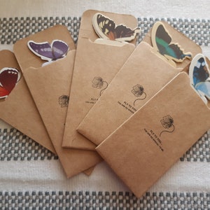 May include: Five brown paper envelopes with butterfly stickers on the front. Each envelope has the text "Fly to you, you are so special to me".