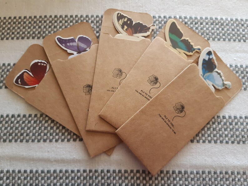 May include: Five brown paper envelopes with butterfly stickers on the front. Each envelope has the text "Fly to you, you are so special to me".