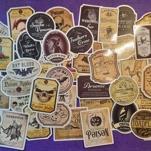 May include: A selection of vintage-style Halloween stickers with various labels. The stickers feature illustrations of skulls, bats, potions, and other spooky elements. Text includes "Poison", "Witch's Brew", and "Bat Blood".