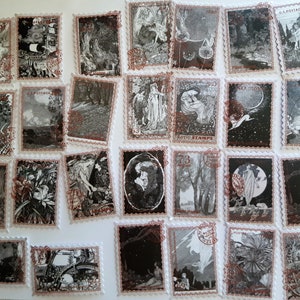 May include: A collection of 25 vintage postage stamps featuring black and white illustrations of fairies, flowers, and other whimsical imagery. The stamps have a distressed, aged look and are printed on white paper with red and brown accents.