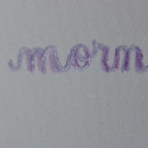Pu&ograve; includere: Messaggio scritto a mano in inchiostro viola che dice "good morning".