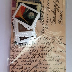 May include: A vintage postcard with handwritten text in black ink. The text reads "49, Avenue de la Douce  Beaunce  Tom Dempsey, Paris". The postcard is decorated with several vintage stamps, including one with a red, white, and blue design and the text "CCCP" and "60".