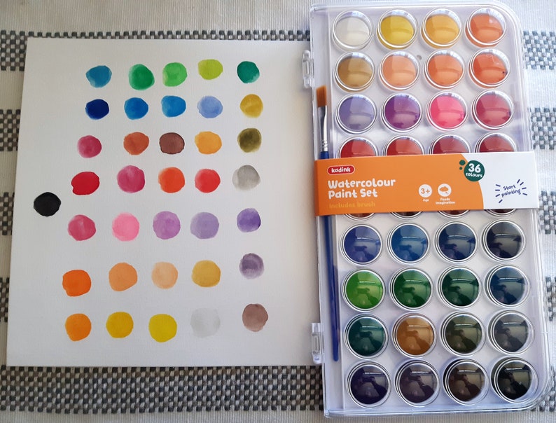 May include: A set of 36 watercolor paints in a plastic case with a brush. The paints are arranged in a grid pattern and include a variety of colors, including red, blue, green, yellow, and brown. The case is labeled "Watercolour Paint Set" and includes 36 colors.