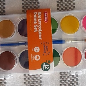 May include: A 12-color watercolor paint set with a brush. The set includes a variety of colors, including red, yellow, blue, green, and brown. The packaging features the text "Watercolour Paint Set" and "12 colours".