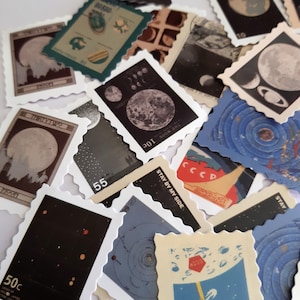 May include: A collection of vintage space-themed stamps featuring images of the moon, planets, and stars. The stamps are printed on white paper with a scalloped edge and have various colors, including blue, red, green, and black.