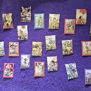 May include: A selection of rectangular fairy-themed images with scalloped edges, arranged on a purple surface. The images show fairies in various settings with flowers and plants. The colour palette includes pink, green, blue, and orange.