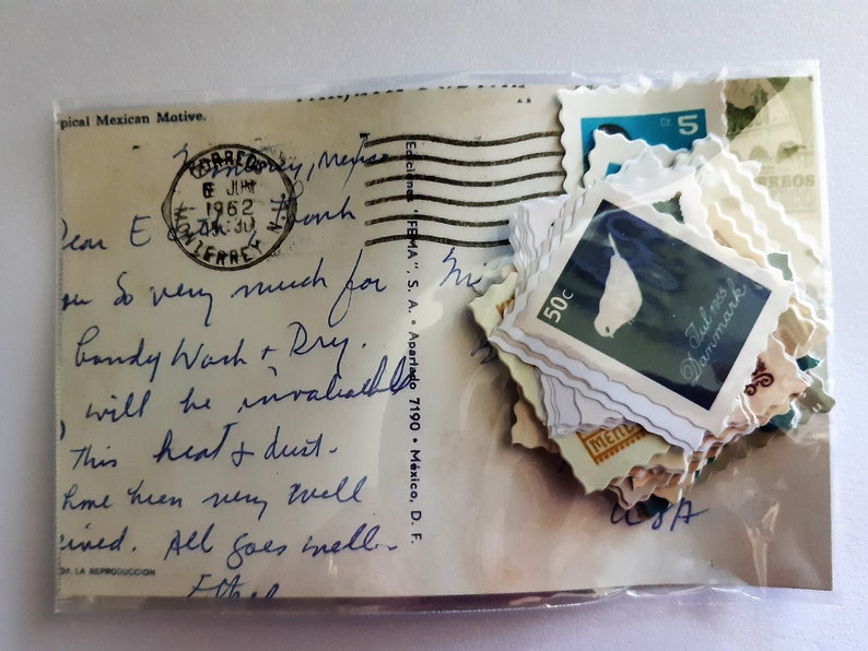 May include: A vintage postcard with a handwritten message and a collection of stamps featuring a bird, a 50c denomination, and the text "Jul s Danmark".