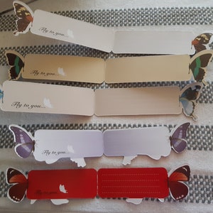 May include: Five colorful butterfly bookmarks with the text "Fly to you..." printed on each. The bookmarks are folded in half and have a blank space for writing.
