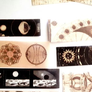 May include: A set of vintage-style illustrations featuring celestial bodies, including the moon, sun, and stars. The illustrations are printed on black and brown paper and feature intricate details. The illustrations are perfect for adding a touch of whimsy to any project.