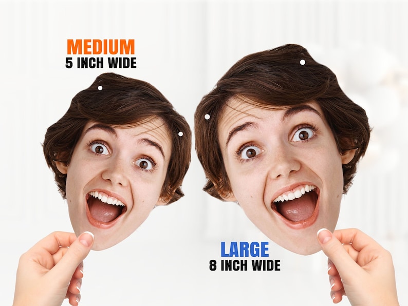 May include: Two cardboard cutouts of a person's face with an open mouth and wide eyes. The cutout on the left is labeled "MEDIUM 5 INCH WIDE" and the cutout on the right is labeled "LARGE 8 INCH WIDE".