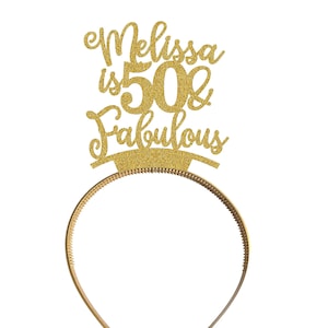 May include: Gold glitter headband with the text "Melissa is 50 & Fabulous" on it.