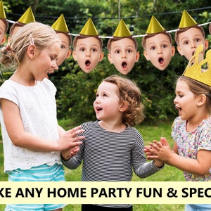 May include: Three children are smiling and laughing while holding a party banner with faces of children wearing party hats. The banner is made of white string with gold party hats and faces printed on it. The banner is hanging from a tree branch. The children are wearing casual clothing. The text "MAKE ANY HOME PARTY FUN & SPECIAL" is at the bottom of the image.