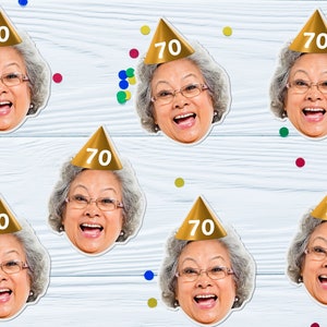 May include: Six gold party hats with the number 70 on them. Each hat is worn by a woman with gray hair and glasses. The background is a white woodgrain surface with colorful confetti.