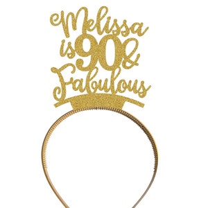 May include: Gold glitter headband with the text "Melissa is 90 & Fabulous" on it.