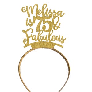 May include: Gold glitter headband with the text "Melissa is 75 & Fabulous" on it.