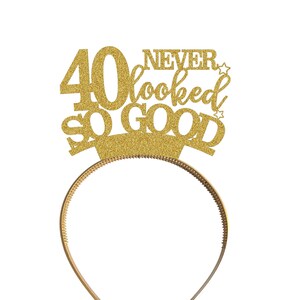 May include: Gold glitter headband with the text "40 Never Looked So Good" on it.