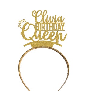 May include: Gold glitter headband with the text "Olivia Birthday Queen" on it.