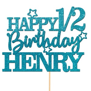 May include: Teal blue glitter cake topper with the text "Happy 1/2 Birthday Henry".