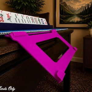 Fuchsia foldable 3D printed PLA hands-free mahjong card holder, slim compact footprint ideal for small card tables and tight game setups.