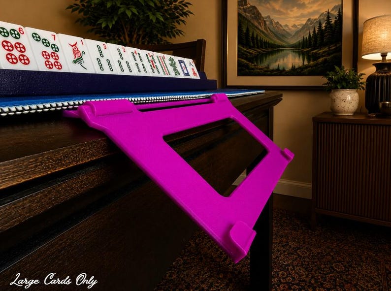 Fuchsia foldable 3D printed PLA hands-free mahjong card holder, slim compact footprint ideal for small card tables and tight game setups.