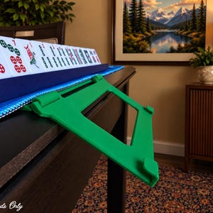 Green foldable 3D printed PLA hands-free mahjong card holder, slim compact footprint ideal for small card tables and tight game setups.
