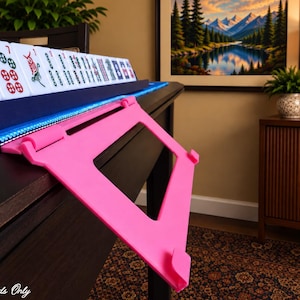 Pink foldable 3D printed PLA hands-free mahjong card holder, slim compact footprint ideal for small card tables and tight game setups.