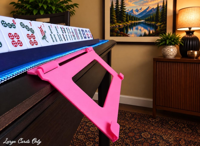 Pink foldable 3D printed PLA hands-free mahjong card holder, slim compact footprint ideal for small card tables and tight game setups.