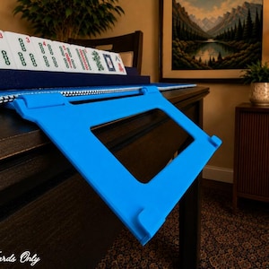 Cyan foldable 3D printed PLA hands-free mahjong card holder, slim compact footprint ideal for small card tables and tight game setups.