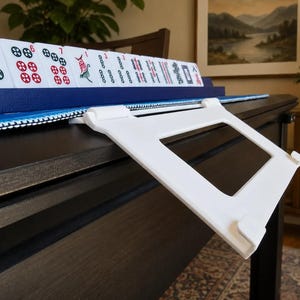 White foldable 3D printed PLA hands-free mahjong card holder, slim compact footprint ideal for small card tables and tight game setups.