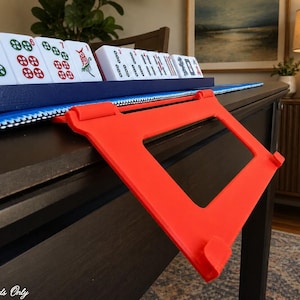 Red foldable 3D printed PLA hands-free mahjong card holder, slim compact footprint ideal for small card tables and tight game setups.