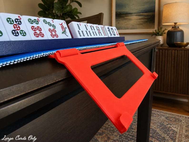 Red foldable 3D printed PLA hands-free mahjong card holder, slim compact footprint ideal for small card tables and tight game setups.