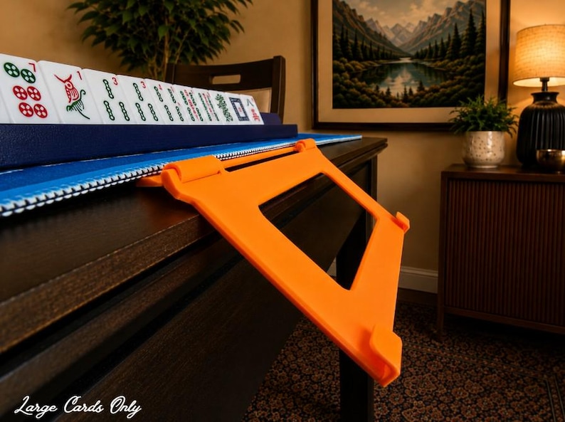 Orange foldable 3D printed PLA hands-free mahjong card holder, slim compact footprint ideal for small card tables and tight game setups.