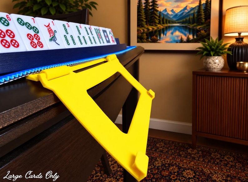 Yellow foldable 3D printed PLA hands-free mahjong card holder, slim compact footprint ideal for small card tables and tight game setups.