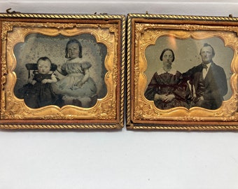 May include: Two antique framed photographs. The first shows a young girl and a toddler, both dressed in clothing from the 1800s. The second shows a couple, also dressed in clothing from the 1800s, standing together.