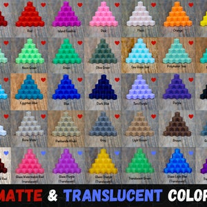May include: A color chart featuring various shades of cubes arranged in a pyramid shape. The chart includes matte and translucent colors, such as red, blue, green, and purple. The text "MATTE & TRANSLUCENT COLORS" is displayed at the bottom.
