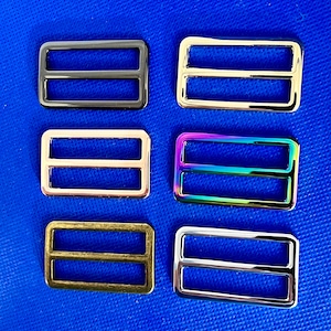 May include: Six different metal slider buckles in various finishes, including black, gold, rose gold, iridescent, antique brass, and silver.