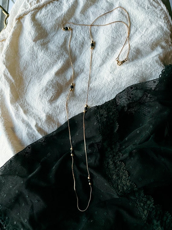 Gold and black necklace - image 1