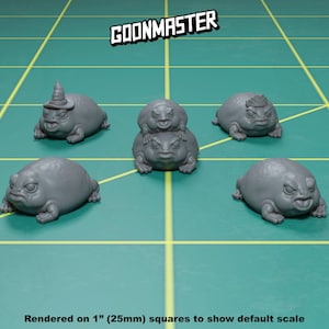May include: Five grey 3D printed frog figurines, each with a unique design. The frogs are posed in a sitting position with their legs outstretched. The figurines are rendered on 1 inch squares to show the default scale.