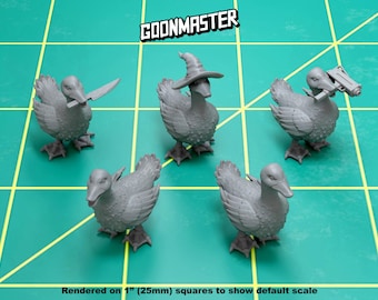 May include: Five gray duck figurines, each with a different accessory. One duck is wearing a wizard hat, another has a knife, another has a gun, and two are plain. The ducks are posed on a green grid background.  GOONMASTER is printed in white on a black rectangle at the top of the image.