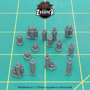 May include: A collection of 16 grey candle miniatures, rendered on 1 inch squares to show scale. The candles are in various shapes and sizes, some with flames.