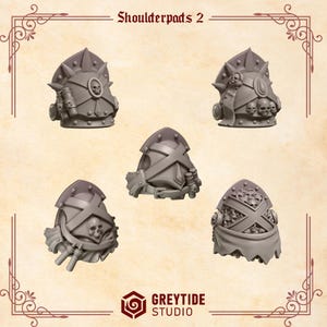 May include: Five gray shoulder pads with skull and cross designs. The shoulder pads have various shapes and details, including spikes and cylindrical attachments. The text "Shoulderpads 2" is at the top.