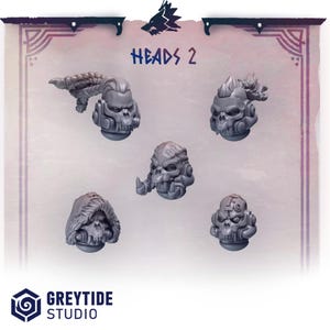 May include: Five gray miniature skull heads with various designs, including one with a braided element and another with a mohawk. The text "HEADS 2" is displayed above the heads. The Greytide Studio logo is at the bottom.