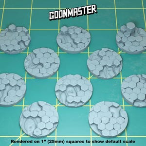 May include: Nine gray plastic round bases with a hexagonal pattern. The bases are 1 inch (25mm) in diameter. The bases are rendered on 1 inch squares to show the default scale. The text "GOONMASTER" is in the top center of the image.