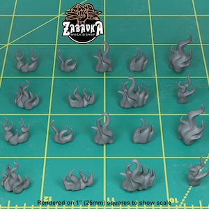 May include: A collection of gray, stylized smoke or flame miniatures. The pieces are arranged on a green grid, with the text "ZABAVKA WORKSHOP" and "Rendered on 1" (25mm) squares to show scale".
