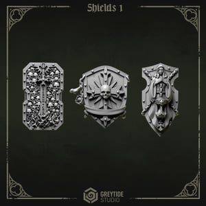 May include: Three gray shields with intricate designs. The first shield is rectangular, covered in skulls and a cross, with the text "Eternum + Crus". The second shield features a skull within a sunburst. The third shield depicts a robed figure.