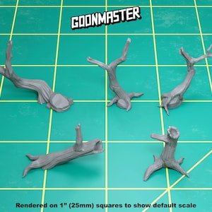 May include: Five gray miniature tree branches are displayed on a green grid. The branches vary in shape and size, with some having multiple offshoots. The text "GOONMASTER" is at the top, and "Rendered on 1" (25mm) squares to show default scale" is at the bottom.